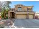 Two-story house with stone accents and a three-car garage at 4221 E Carriage Way, Gilbert, AZ 85297