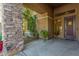 Inviting entryway with stone detailing and a covered porch at 4221 E Carriage Way, Gilbert, AZ 85297