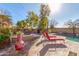 Relaxing pool area with lounge chairs and a fire pit at 4221 E Carriage Way, Gilbert, AZ 85297