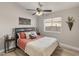 Bright bedroom with a queen bed, ceiling fan, and wood-look floors at 4233 E Creosote Dr, Cave Creek, AZ 85331