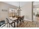 Dining area with wood table and chandelier, adjacent to living room at 4233 E Creosote Dr, Cave Creek, AZ 85331