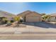 Single-story house with tan exterior, two-car garage, and desert landscaping at 4233 E Creosote Dr, Cave Creek, AZ 85331