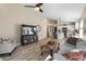 Open concept living room with kitchen view, gray sofa, and wood coffee table at 4233 E Creosote Dr, Cave Creek, AZ 85331