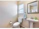 Small bathroom with pedestal sink and toilet at 4333 W Shaw Butte Dr, Glendale, AZ 85304