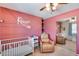 Bedroom with crib, accent wall, and mirrored closet at 4333 W Shaw Butte Dr, Glendale, AZ 85304