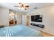 Main bedroom with ensuite bathroom access and mounted TV at 4333 W Shaw Butte Dr, Glendale, AZ 85304