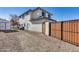 Side view of house showcasing a gravel driveway and wooden fence at 4333 W Shaw Butte Dr, Glendale, AZ 85304