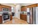 Kitchen with stainless steel appliances and wood cabinets at 4333 W Shaw Butte Dr, Glendale, AZ 85304