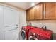 Laundry room with washer, dryer, and upper cabinets at 4333 W Shaw Butte Dr, Glendale, AZ 85304