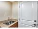 A laundry room with a utility sink and built-in cabinets at 4333 W Shaw Butte Dr, Glendale, AZ 85304