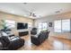 Living room with a large TV, reclining furniture, and tile floor at 4333 W Shaw Butte Dr, Glendale, AZ 85304