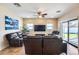 Spacious living room with leather furniture and large TV at 4333 W Shaw Butte Dr, Glendale, AZ 85304