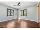 Light and airy bedroom with hardwood floors and two windows at 4602 E Arcadia Ln, Phoenix, AZ 85018