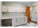 Laundry room with built-in cabinets and countertop workspace at 4602 E Arcadia Ln, Phoenix, AZ 85018