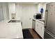 White kitchen with stainless steel appliances and dark floors at 4760 E Portland St, Phoenix, AZ 85008