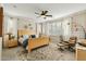 Bright bedroom with a light wood bed frame, ceiling fan, and large windows at 4910 S Huachuca Pl, Chandler, AZ 85249