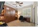 Home office with built-in murphy bed, desk, and ample shelving at 4910 S Huachuca Pl, Chandler, AZ 85249