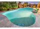 Relaxing freeform pool with a spa and waterfall feature at 4910 S Huachuca Pl, Chandler, AZ 85249