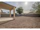 Covered patio and gravel backyard with block wall at 4933 E Meadow Mist Ln, San Tan Valley, AZ 85140