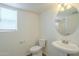 Clean bathroom with pedestal sink, toilet and mirror at 4933 E Meadow Mist Ln, San Tan Valley, AZ 85140