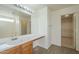 Bathroom with wood vanity, large mirror and walk-in closet at 4933 E Meadow Mist Ln, San Tan Valley, AZ 85140