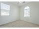 Simple carpeted bedroom with ceiling fan and window at 4933 E Meadow Mist Ln, San Tan Valley, AZ 85140