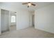 Bedroom with mirrored closet and ceiling fan at 4933 E Meadow Mist Ln, San Tan Valley, AZ 85140