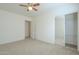 Bedroom with mirrored closet doors and ceiling fan at 4933 E Meadow Mist Ln, San Tan Valley, AZ 85140