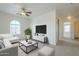 Cozy bonus room with a large window, a comfortable sectional, and modern décor, designed for relaxation at 4933 E Meadow Mist Ln, San Tan Valley, AZ 85140