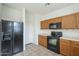 Kitchen features black appliances and ample cabinet space at 4933 E Meadow Mist Ln, San Tan Valley, AZ 85140