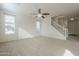 Bright living room with neutral carpeting and a staircase at 4933 E Meadow Mist Ln, San Tan Valley, AZ 85140