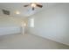 Spacious loft area with carpeted floors and a ceiling fan at 4933 E Meadow Mist Ln, San Tan Valley, AZ 85140