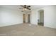 Main bedroom with ceiling fan and walk-in closet at 4933 E Meadow Mist Ln, San Tan Valley, AZ 85140