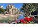 Residential building with canal views and red flowers in foreground at 5138 N 78Th St, Scottsdale, AZ 85250