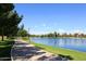 Scenic lakeside walking path with lush greenery and trees at 5138 N 78Th St, Scottsdale, AZ 85250