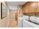 Laundry room with washer, dryer, and extra storage cabinets at 5138 N 78Th St, Scottsdale, AZ 85250