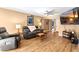 Living room with hardwood floors, a large TV, and comfortable gray reclining chairs at 5138 N 78Th St, Scottsdale, AZ 85250