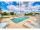 Community pool with lounge chairs and tables at 5138 N 78Th St, Scottsdale, AZ 85250