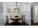 Charming dining area with round wooden table and chandelier at 533 W Guadalupe Rd # 1069, Mesa, AZ 85210