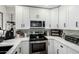 Modern white kitchen with stainless steel appliances at 533 W Guadalupe Rd # 1069, Mesa, AZ 85210