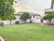 Landscaped backyard with grassy area and mature trees at 5345 E Mclellan Rd # 98, Mesa, AZ 85205