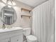 Bathroom with white vanity and round mirror at 557 S Visalia St, Mesa, AZ 85202