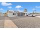 Ranch style home with a paved walkway, gravel driveway and solar panels at 557 S Visalia St, Mesa, AZ 85202