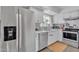 Clean and bright kitchen with stainless steel appliances and white cabinets at 557 S Visalia St, Mesa, AZ 85202