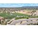 Aerial view of golf course driving range and community at 6688 S Cartier Dr, Gilbert, AZ 85298