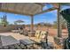 Relaxing patio with pergola, seating, and mountain views at 6688 S Cartier Dr, Gilbert, AZ 85298