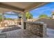 Stone patio with built-in bar and seating area at 6688 S Cartier Dr, Gilbert, AZ 85298