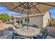 Patio dining area with umbrella and mosaic table at 6688 S Cartier Dr, Gilbert, AZ 85298