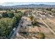 Aerial view of a house and large lot with playground; mountain views at 6841 N 183Rd Ave, Waddell, AZ 85355