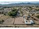 Aerial view showing a house, riding arena, and expansive land with mountain views at 6841 N 183Rd Ave, Waddell, AZ 85355